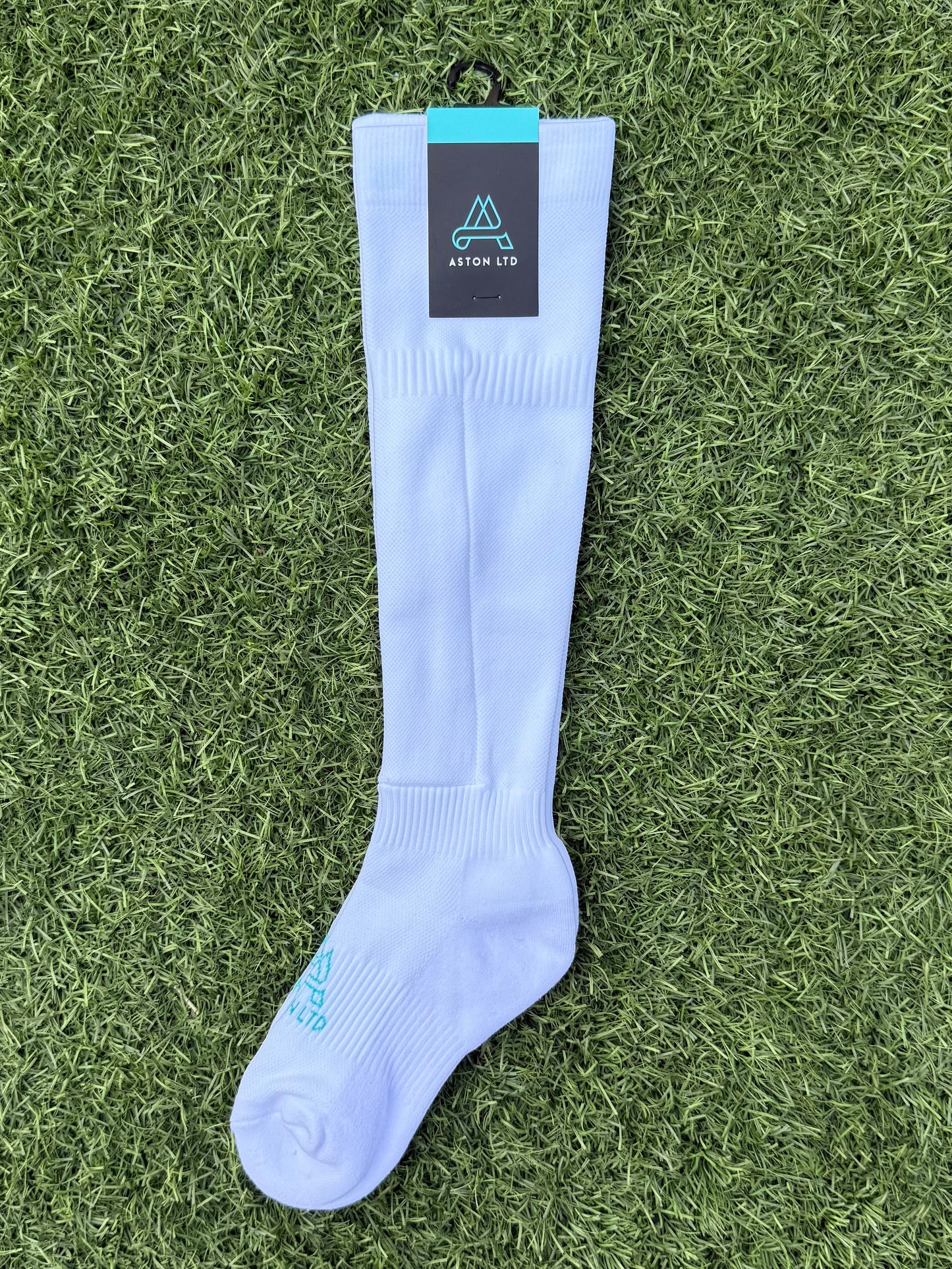 White knee high soccer sock with built in shin guard pocket.